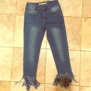 Vintage Havana jeans with fringed denim cuffs.